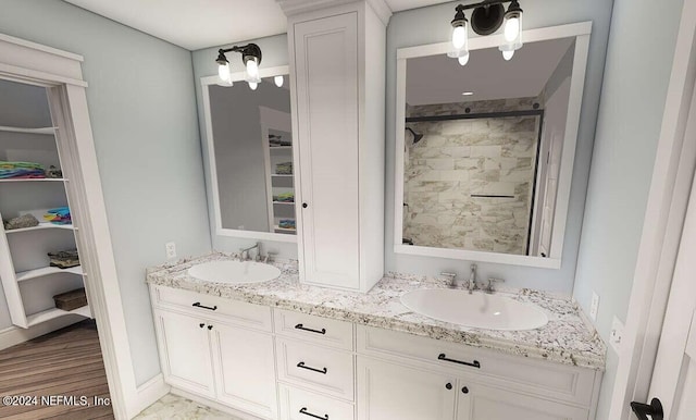 bathroom featuring vanity, hardwood / wood-style floors, and tiled shower