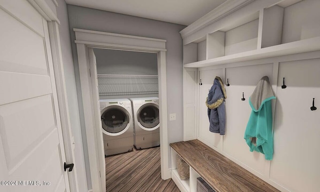 laundry area with dark wood-type flooring and washer and dryer