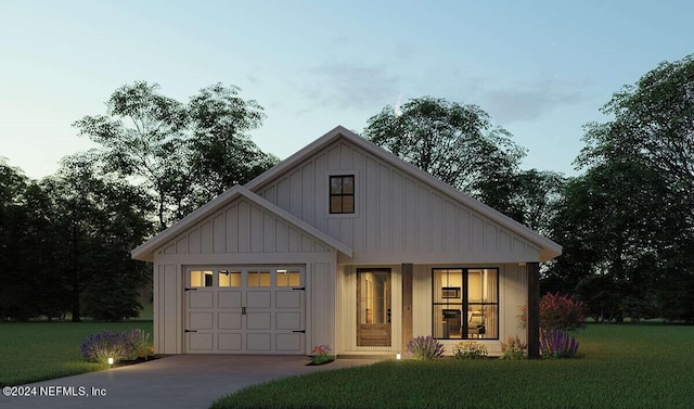 modern farmhouse style home featuring a front yard and a garage