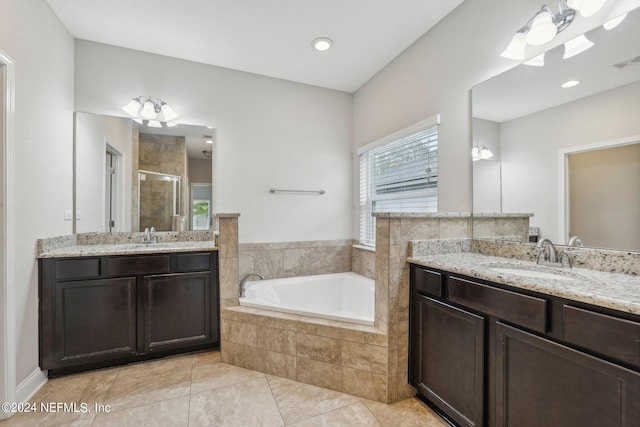 bathroom with tile patterned floors, vanity, and separate shower and tub