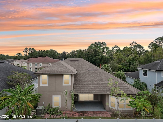 view of back house at dusk