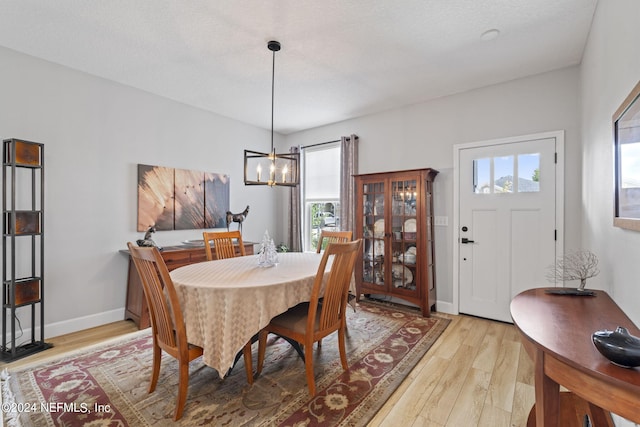 dining room with a notable chandelier and light hardwood / wood-style floors