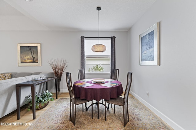 dining space with a textured ceiling