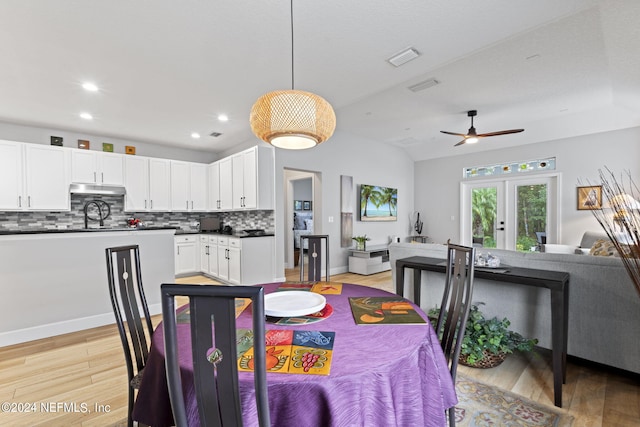 dining area featuring french doors, vaulted ceiling, ceiling fan, and light hardwood / wood-style flooring