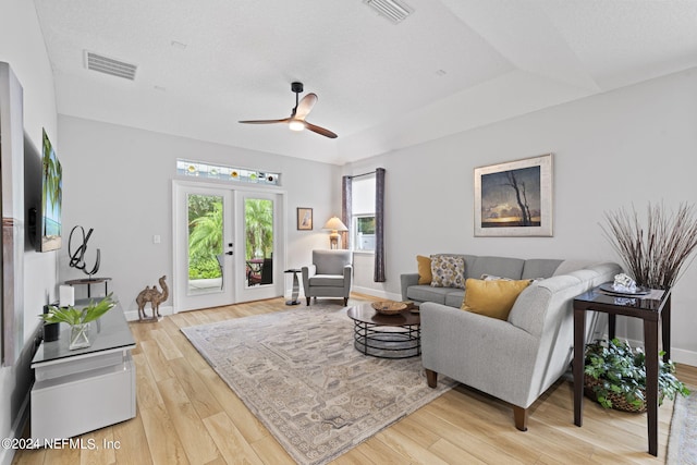 living room with french doors, ceiling fan, and light hardwood / wood-style flooring