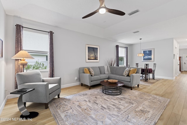 living room featuring ceiling fan and light hardwood / wood-style flooring