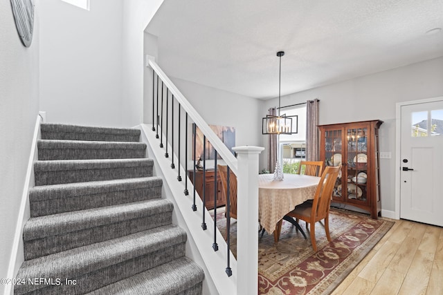 dining space featuring hardwood / wood-style floors and a notable chandelier