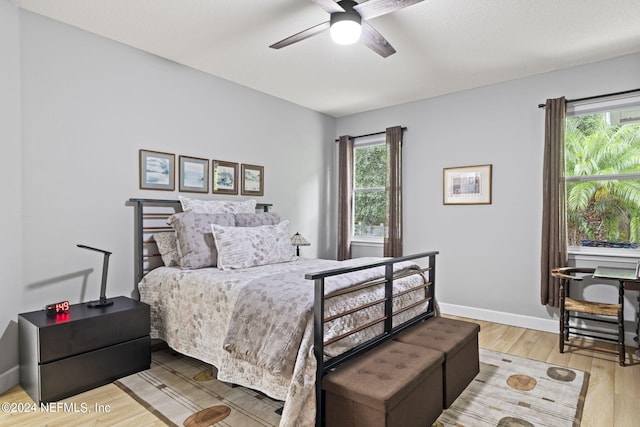 bedroom with ceiling fan and hardwood / wood-style floors