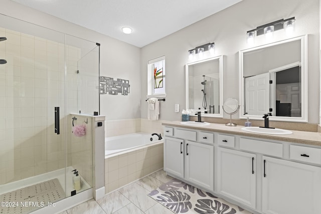 bathroom featuring vanity and separate shower and tub