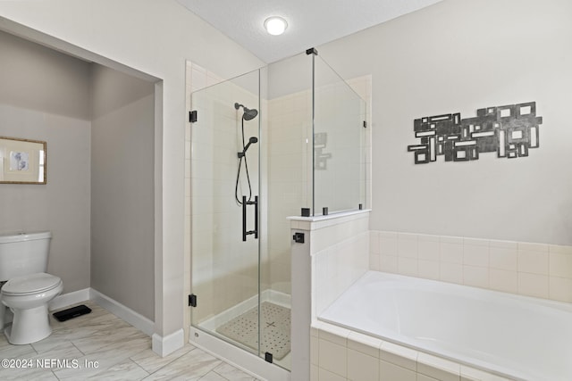 bathroom featuring toilet, shower with separate bathtub, and a textured ceiling