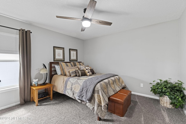 carpeted bedroom with ceiling fan and a textured ceiling