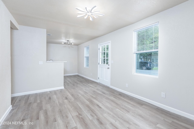 spare room featuring light wood-type flooring