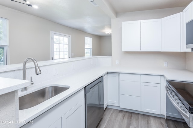 kitchen featuring light hardwood / wood-style floors, white cabinetry, light stone countertops, stainless steel appliances, and sink