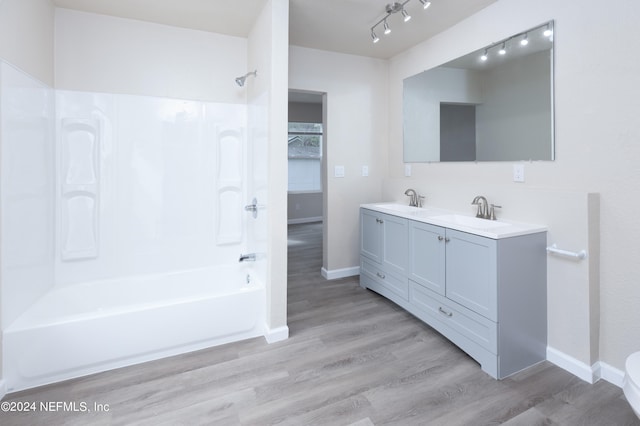 bathroom featuring vanity, shower / bath combination, and hardwood / wood-style flooring