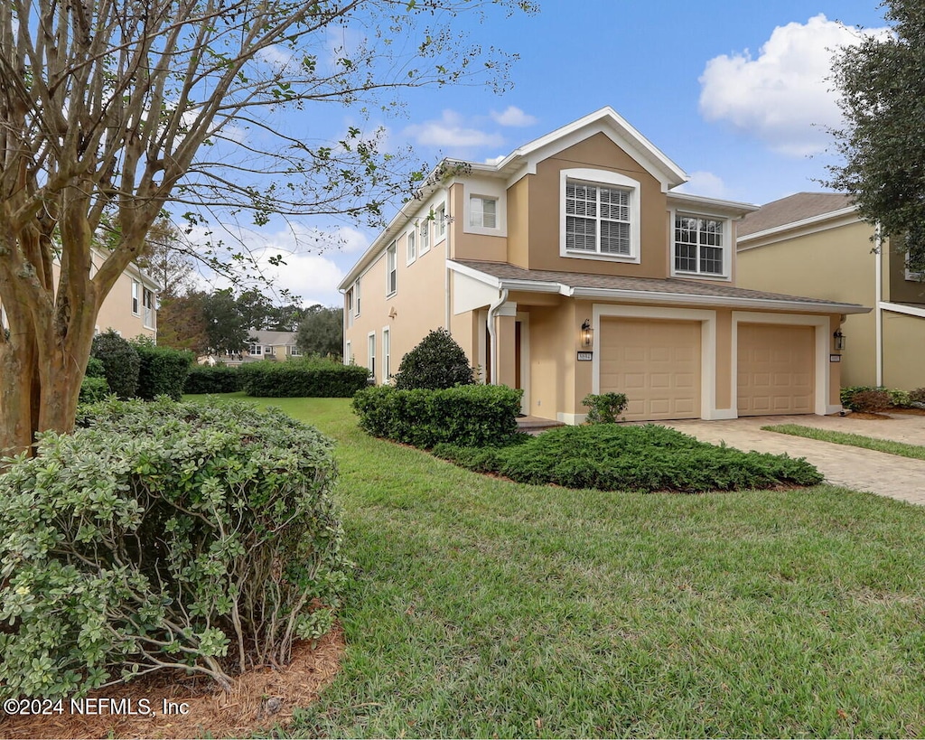 view of front of property featuring a garage and a front yard