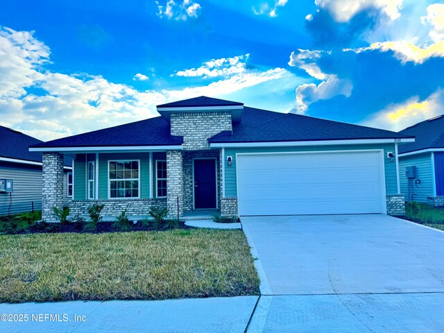 view of front of home with a garage and a front yard