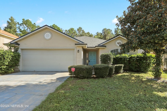 ranch-style home featuring a garage and a front yard