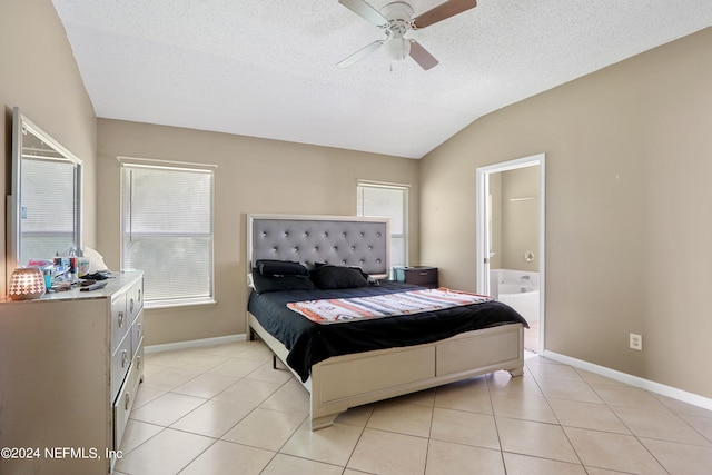 bedroom featuring a textured ceiling, ceiling fan, light tile patterned floors, and lofted ceiling