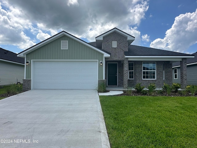 view of front of house featuring a garage and a front lawn