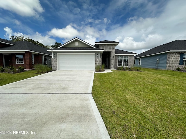 view of front of home with a garage and a front lawn