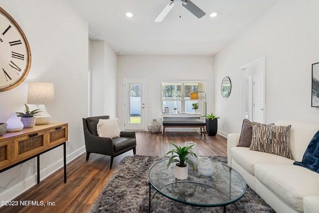 living room with ceiling fan and dark wood-type flooring