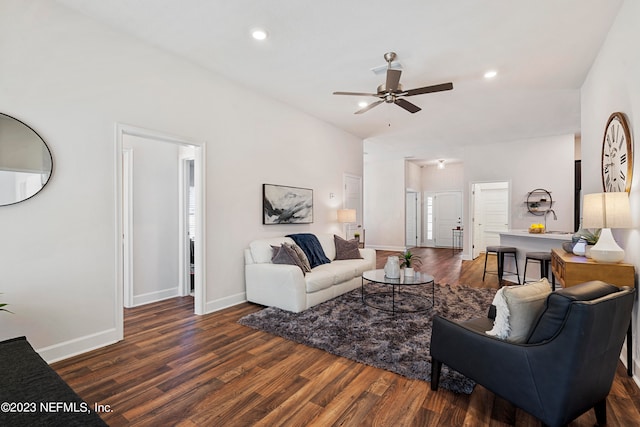 living room featuring ceiling fan and dark hardwood / wood-style floors