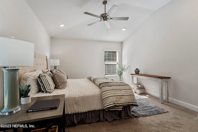 carpeted bedroom with vaulted ceiling and ceiling fan