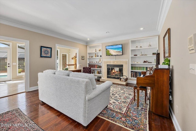 living room featuring crown molding, built in features, and dark hardwood / wood-style floors