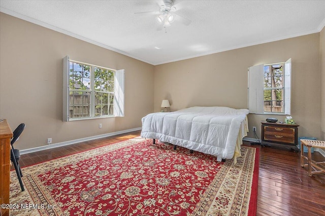 bedroom with ornamental molding, dark hardwood / wood-style flooring, a textured ceiling, and ceiling fan