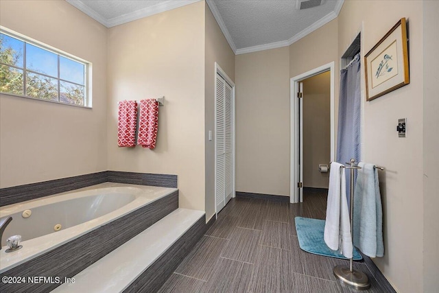 bathroom with a textured ceiling, a bathing tub, and ornamental molding