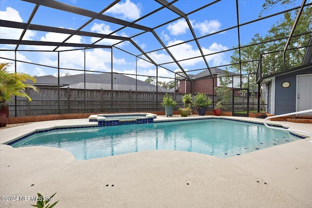 view of pool featuring a lanai, an in ground hot tub, and a patio area