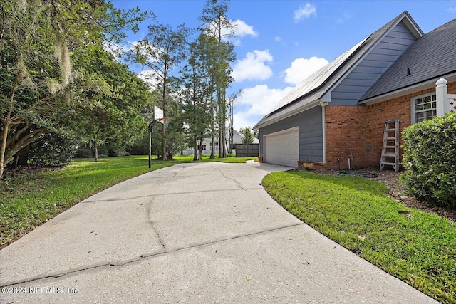 view of home's exterior with a yard and a garage