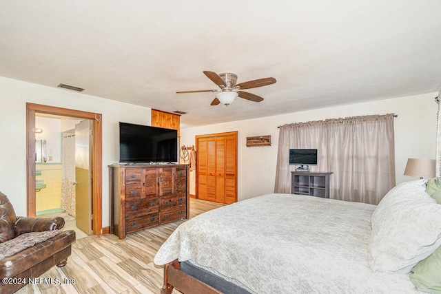 bedroom featuring ensuite bathroom, ceiling fan, a closet, and light hardwood / wood-style floors