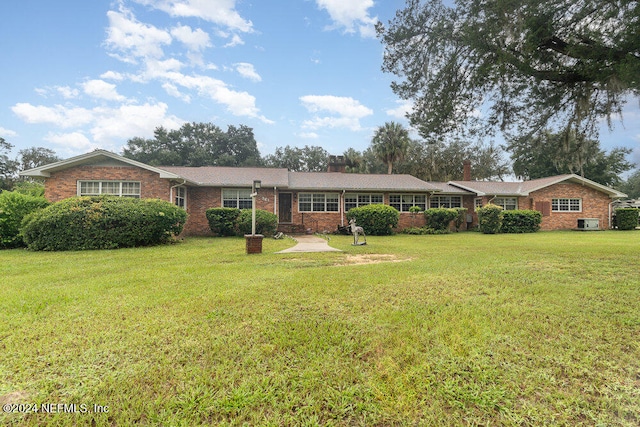 ranch-style house with a front lawn