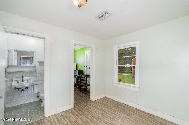 spare room featuring light hardwood / wood-style flooring and sink