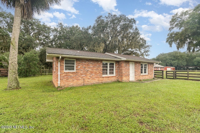 back of property with a lawn