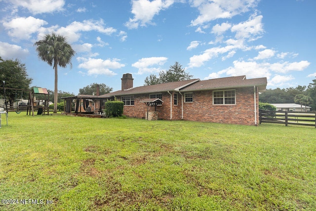 rear view of house with a lawn