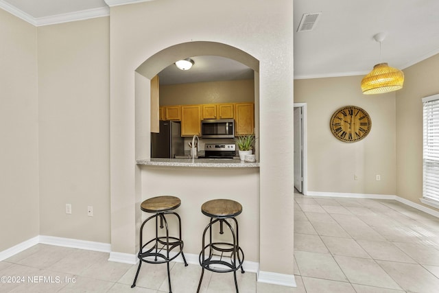 kitchen featuring light tile patterned floors, arched walkways, appliances with stainless steel finishes, ornamental molding, and visible vents