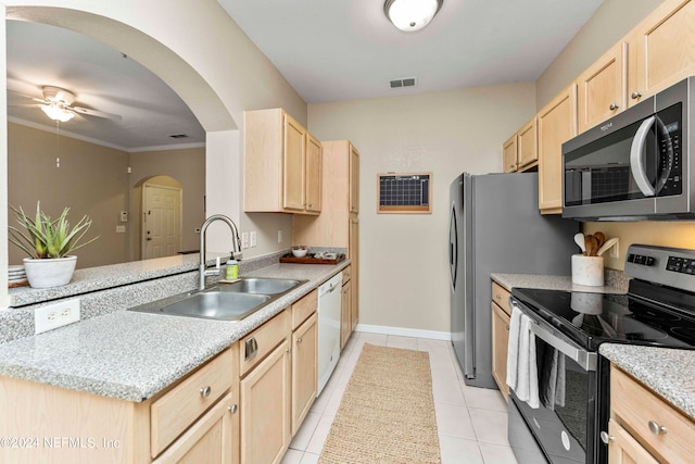 kitchen featuring light brown cabinetry, crown molding, sink, stainless steel appliances, and light tile patterned floors