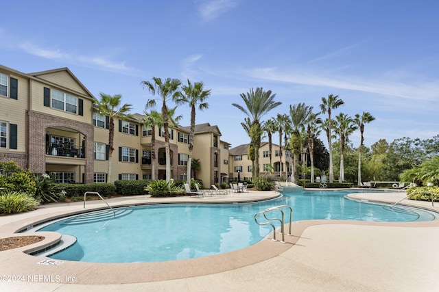 community pool featuring a residential view and a patio area