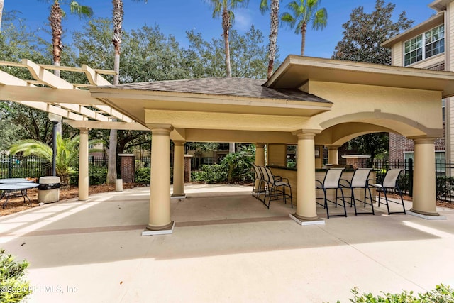 surrounding community featuring a patio, exterior bar, and a pergola