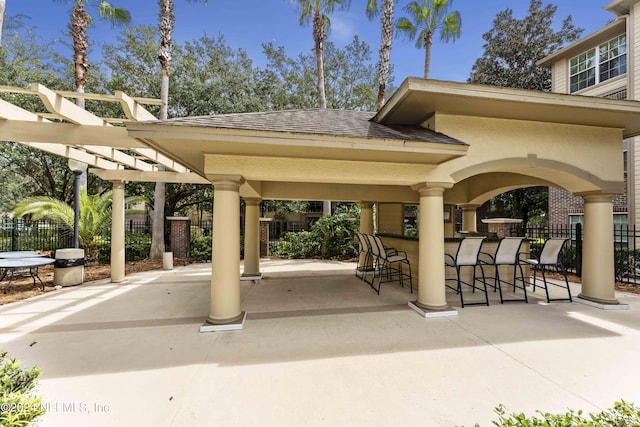 view of home's community with a pergola, outdoor dry bar, a patio, and fence