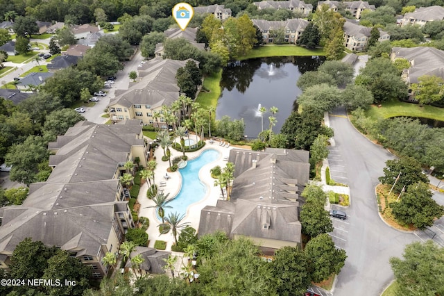 drone / aerial view with a residential view and a water view