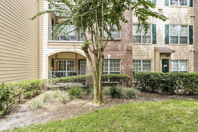 view of home's exterior with covered porch and a balcony