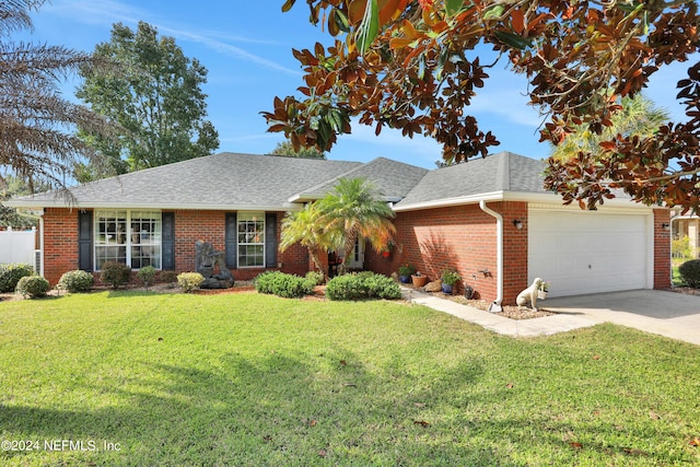 ranch-style house featuring a front yard and a garage