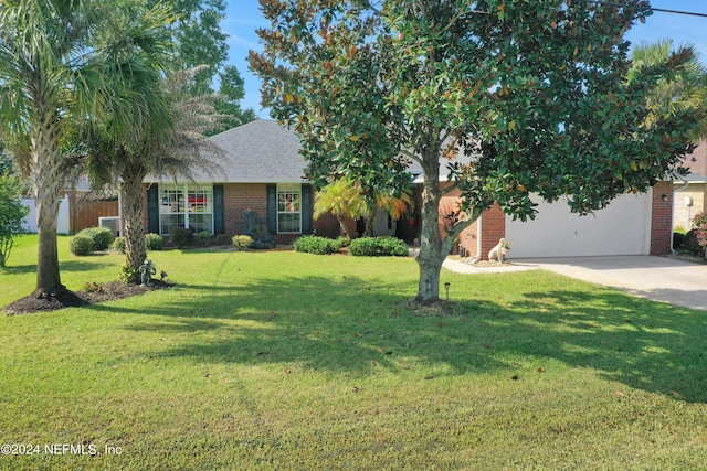 view of front of home with a front yard and a garage