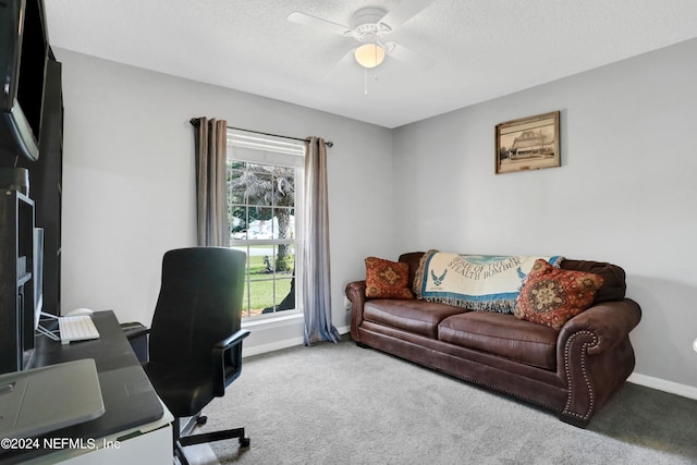 carpeted office space featuring a textured ceiling and ceiling fan