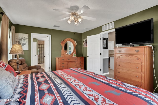 bedroom featuring ceiling fan and a textured ceiling