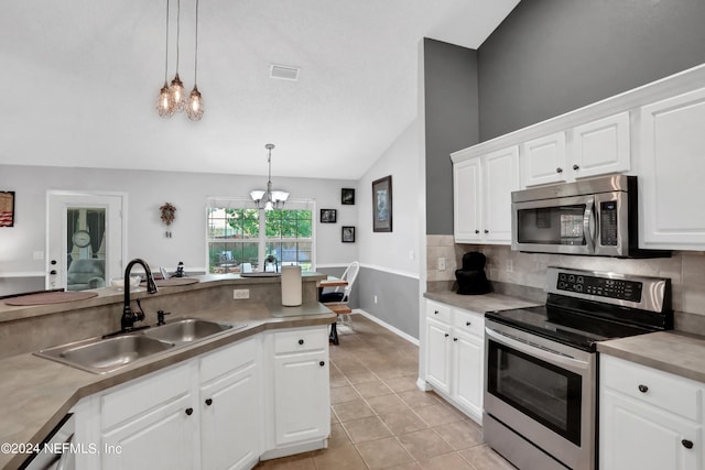 kitchen featuring white cabinetry, stainless steel appliances, lofted ceiling, decorative light fixtures, and sink