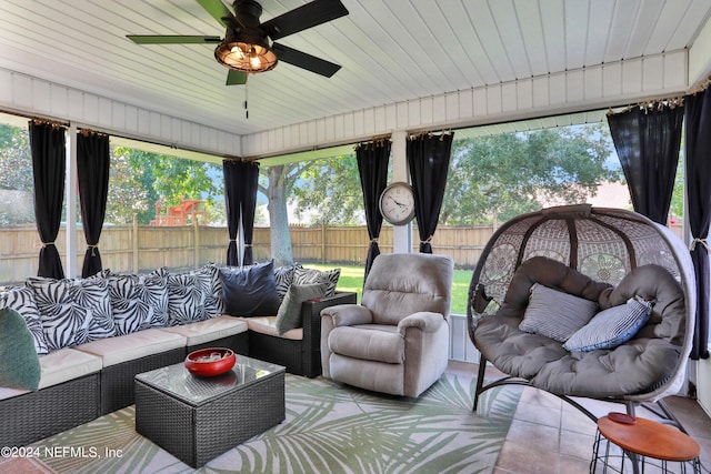 sunroom featuring wood ceiling, a wealth of natural light, and ceiling fan